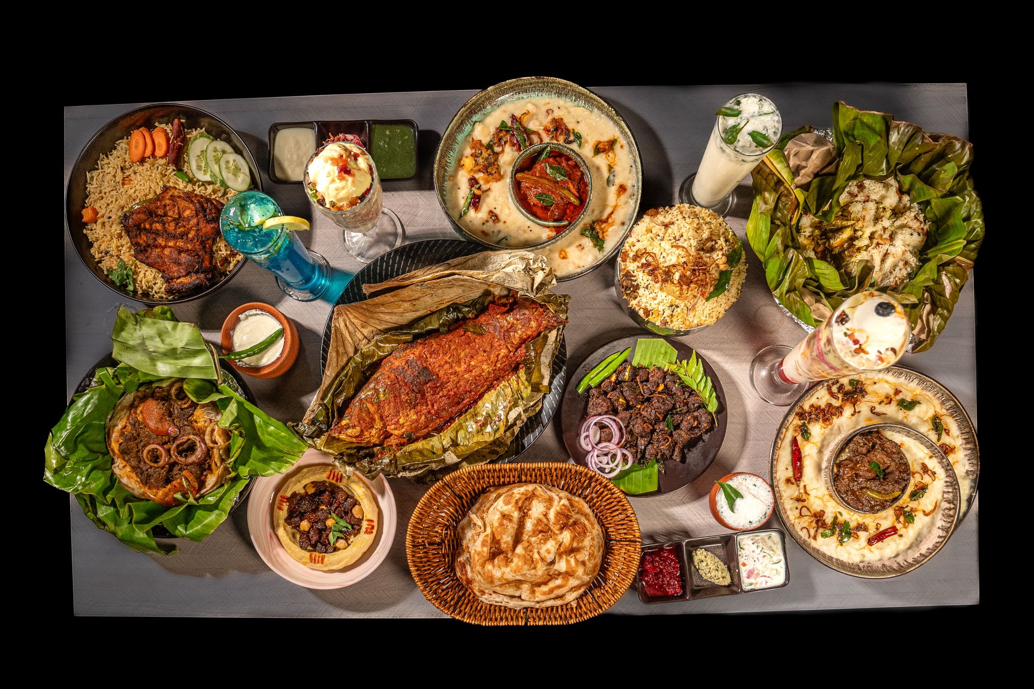 Full Kerala feast top-down at Café Malabar Singapore — biryani, parotta, curries and chaya on Arab Street.