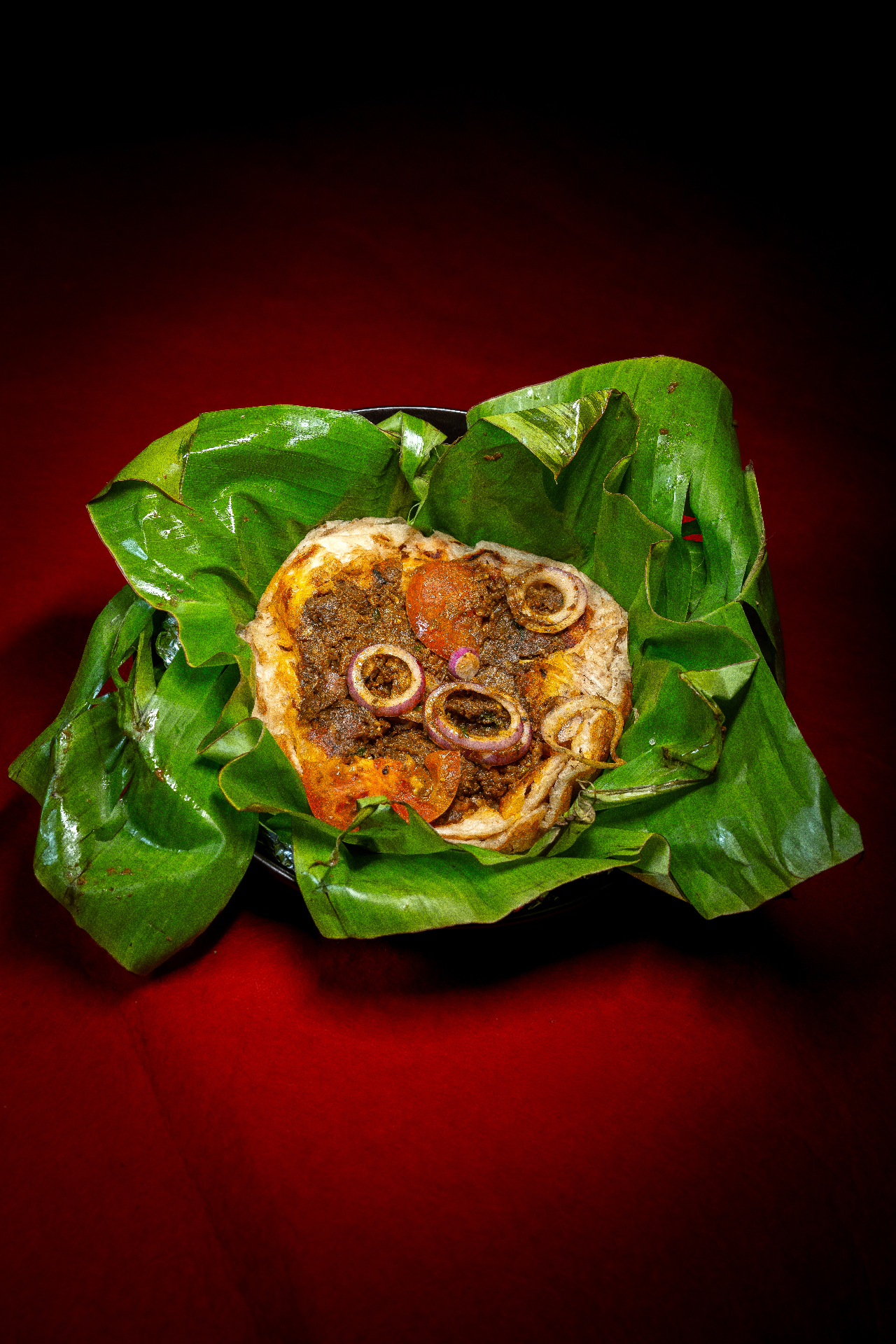 Kizhi Parotta — Parotta and gravy sealed in banana leaf.. Served at Café Malabar, authentic Kerala & Malabar restaurant at 142 Arab Street, Singapore.